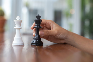 Asia children playing chess on a white table, chessboard game player education learning for developing thinking,
 strategy competition concentration to victory, Concept: Planning teamwork for success