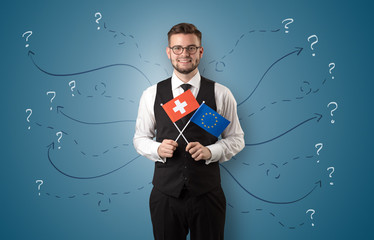 Smiling young man standing with flag and multidirectional arrows around
