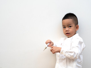 sick boy with thermometer in hand on white background