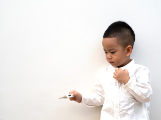 sick boy with thermometer in hand on white background