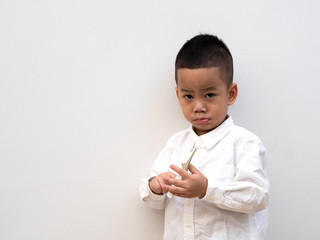 sick boy with thermometer in hand on white background