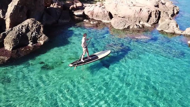 Aerial drone video of competition sport paddle surfing or sup in tropical Caribbean sea
