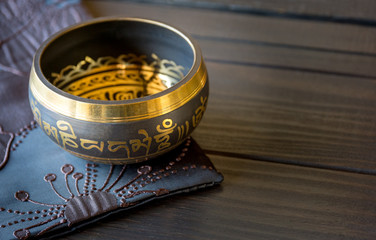 Tibetan singing bowl on top of a wooden table