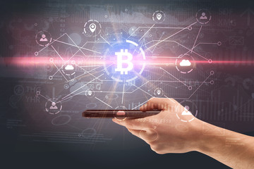 Obraz premium Hand using phone with cryptocurrency bitcoin link network and online concept 