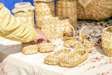 The market sells handmade products made of birch bark bast shoes and baskets