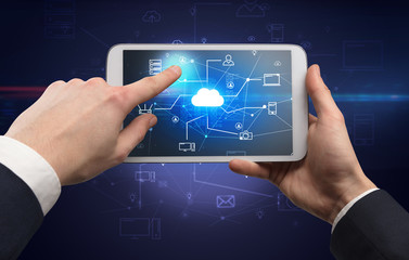 First person view of a hand using tablet with cloud office concept
