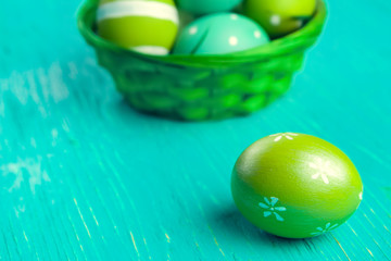 Green Easter eggs on wooden table