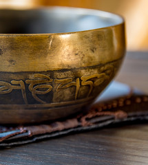 Tibetan singing bowl on top of a wooden table