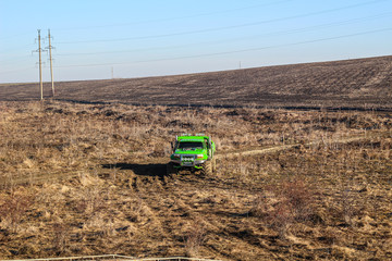 Fototapeta premium Ukrainian offroad competition in the city of Kamyanets Podilsky. Swamp and mud on cars. Produce large puddles