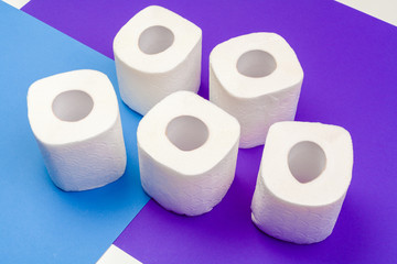Rolls of toilet paper on color background, top view