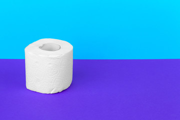 Toilet paper isolated on white table with blue background. Cleaning concept product