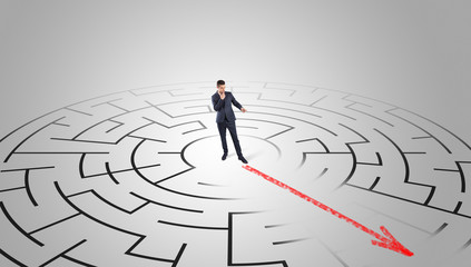 Businessman going through the maze with red arrow
