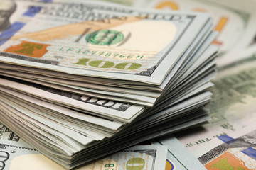 Stack of one hundred dollar bills close-up.