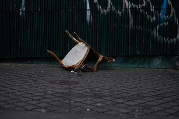 Old upturned chair upside down on a city street