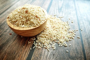 Close up of dirty rice on wooden bowl.
