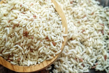 Close up of dirty rice on wooden bowl.