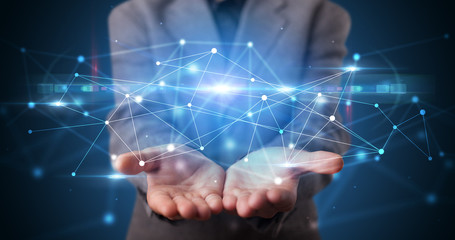 Handsome person holding hologram screen displaying modern cloud based web system technology
