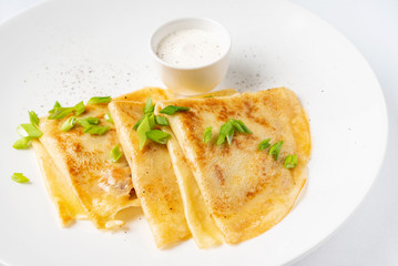 Crepes Suzette with sour cream on the white background