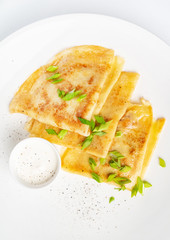 Crepes Suzette with sour cream on the white background