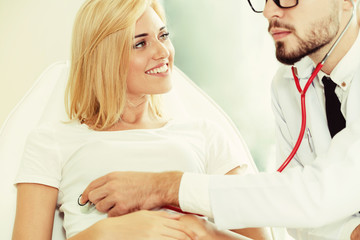 Male Doctor and Female Patient in Hospital Office