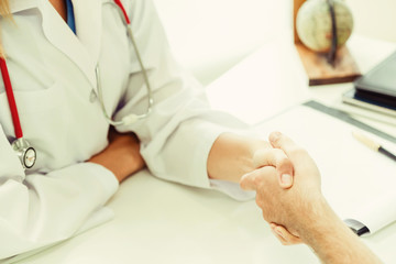 Woman Doctor and Male Patient in Hospital Office