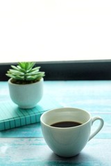  Close up of coffee cup on wooden table. 