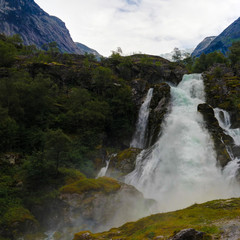 Fototapeta na wymiar Panoramic view to kleivafossen waterfall at briksdalselva river, Briksdalsbreen glacier, Norway