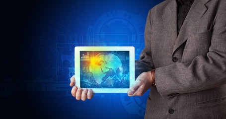 Hand holding tablet with global database concept
