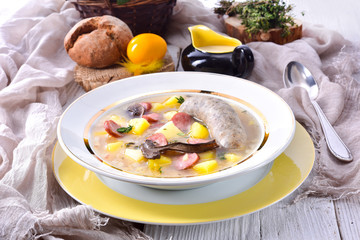 a polish easter soup with homemade white sausage and mushrooms