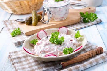 delicious homemade meat salad with mayonnaise and cucumber