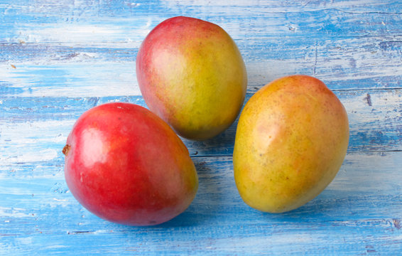 ripe, juicy mango on a wooden background
