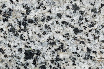 Marble texture with different colored spots. The surface of granite stone with streaks, spots and patterns of different colors. Visible stone texture with thick lines and mottled spots. 