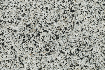 Marble texture with different colored spots. The surface of granite stone with streaks, spots and patterns of different colors. Visible stone texture with thick lines and mottled spots. 