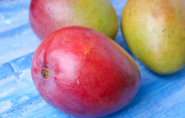 ripe, juicy mango on a wooden background