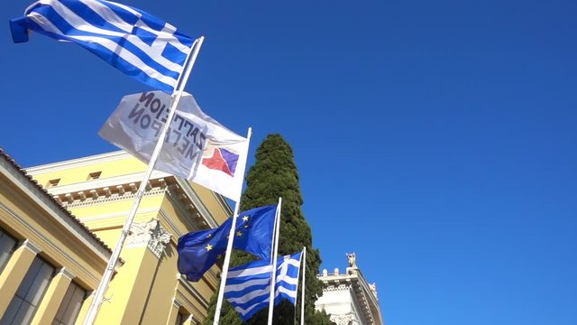 Slow motion video from iconic public Zappeion hall with Greek flag waving, Athens historic center, Attica, Greece