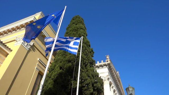 Slow motion video from iconic public Zappeion hall with Greek flag waving, Athens historic center, Attica, Greece