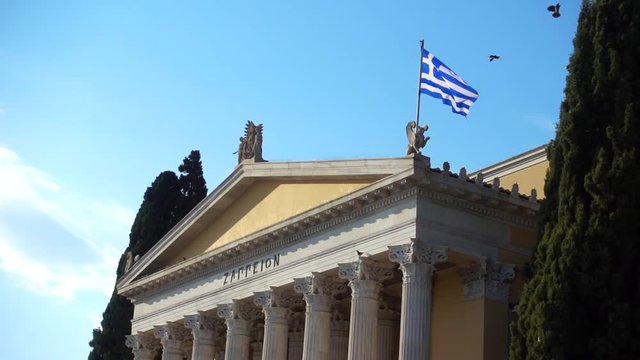 Slow motion video from iconic public Zappeion hall with Greek flag waving, Athens historic center, Attica, Greece