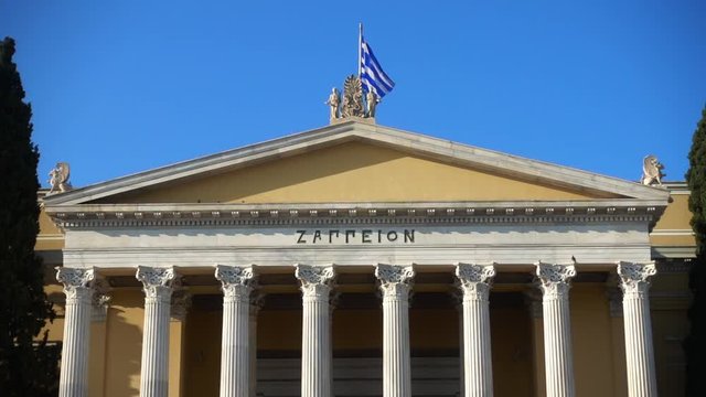 Slow motion video from iconic public Zappeion hall with Greek flag waving, Athens historic center, Attica, Greece