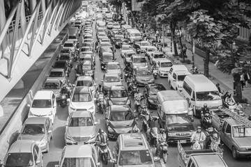 Many cars are stop and waiting for the green traffic light at a junction during rush hour and traffic jam on Sathorn Road in Bangkok