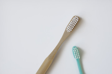 natural bamboo toothbrush versus plastic blue brush