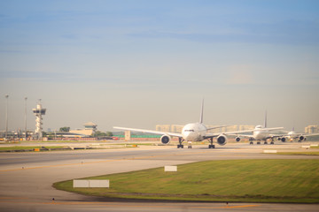 Fototapeta na wymiar Thai airways airplane is taxiing on runway before taking-off at Suvarnabhumi international airport.