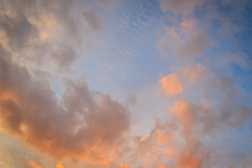 Red cloud and blue sky background. Dramatic sunset sky began to change from blue to orange.