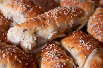 Fresh and hot homemade roll pastry with cheese and sesame