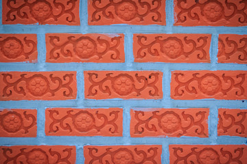 Bright red brick with flower ivy patterned wall background.