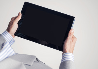 Hands of businessman holding tablet pc with black screen