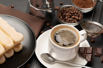 Italian Savoiardi ladyfingers Biscuits and cup of coffee on concrete backgound