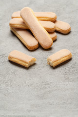 Italian Savoiardi ladyfingers Biscuits on concrete backgound