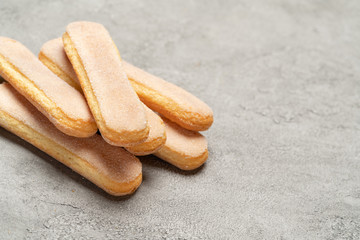 Italian Savoiardi ladyfingers Biscuits on concrete backgound