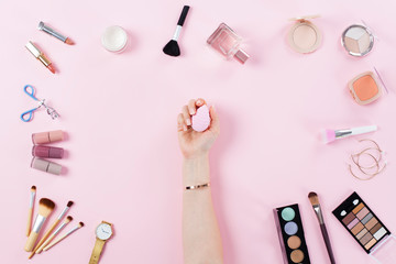 Various beauty products on pink background