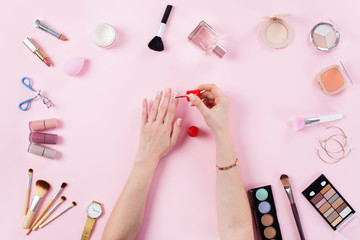 Make up products with woman doing nail polish